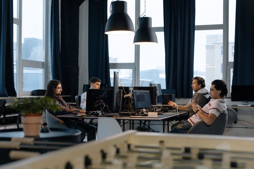 Mastering the First Impression: Your intriguing post title goes here Workers collaborate in a modern office with computers, showcasing teamwork in technology development.